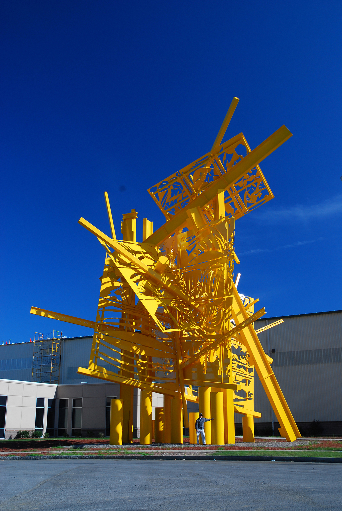 A yellow sculpture by Albert Paley