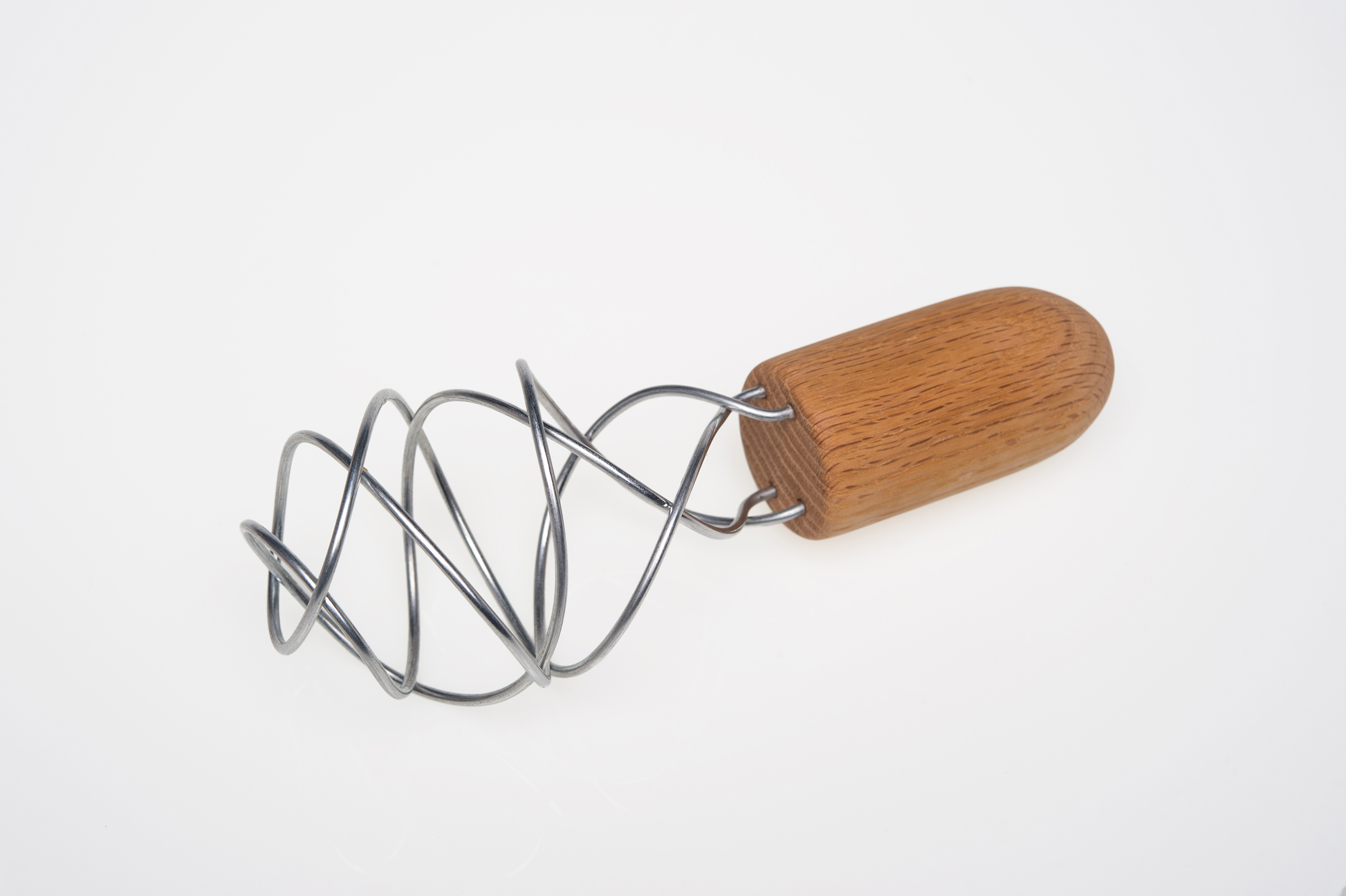 A wooden-handled whisk