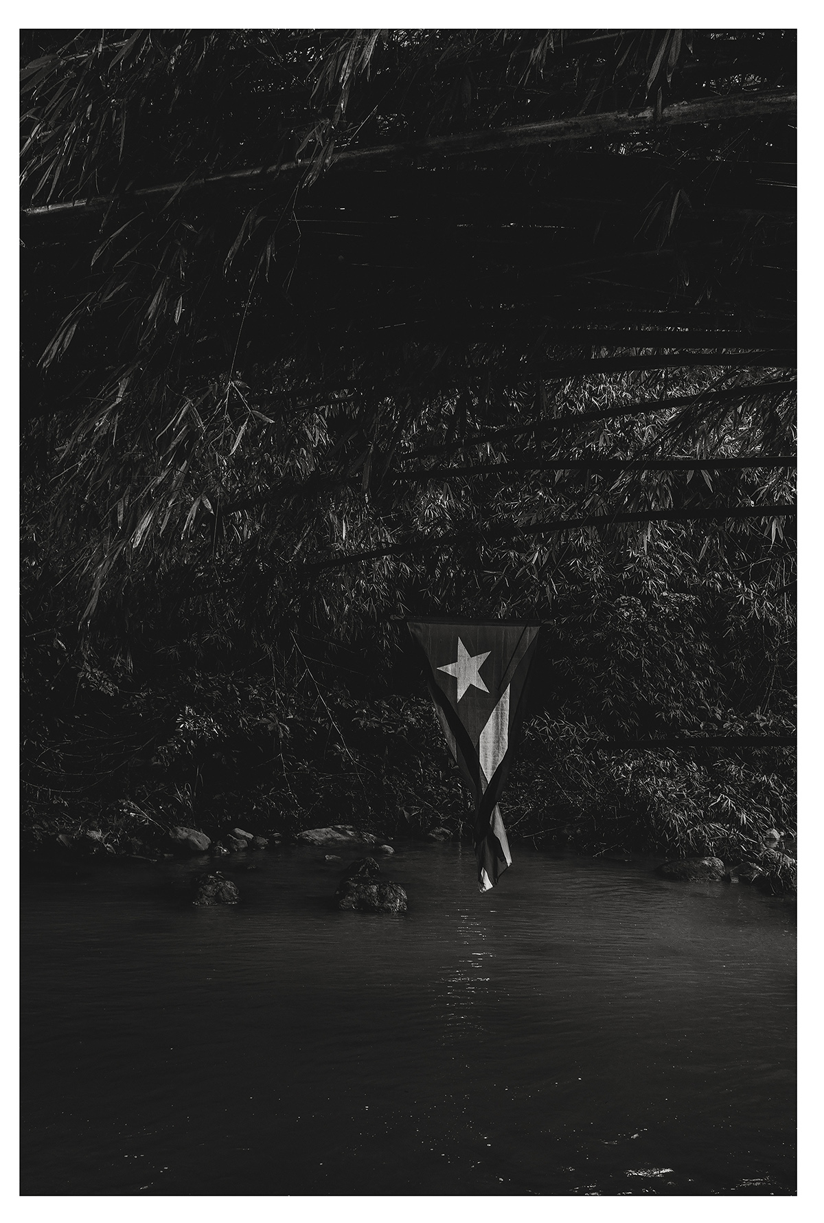 A Puerto Rican flag hangs above a body of water.
