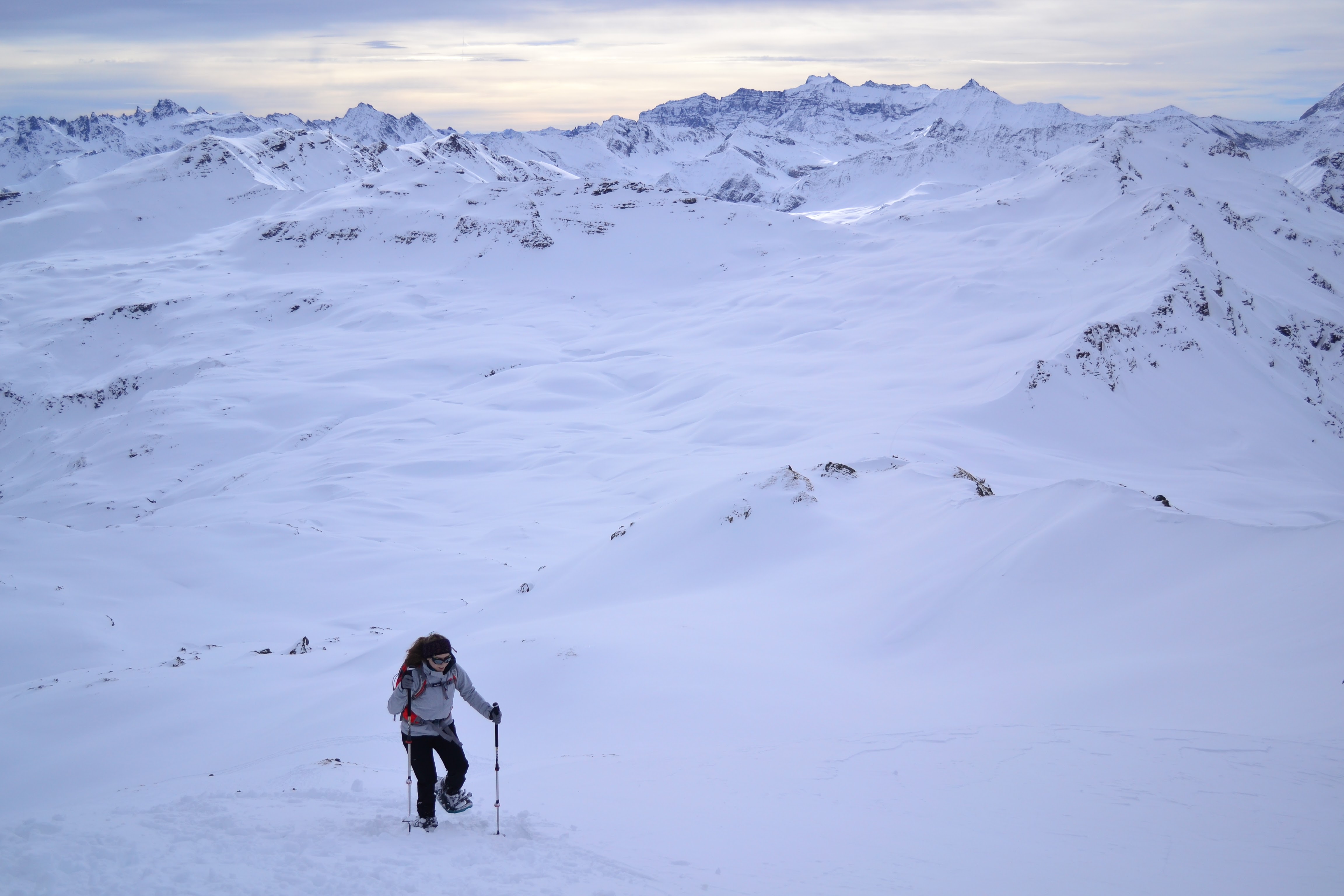 Person snow shoes up a snow covered mountain