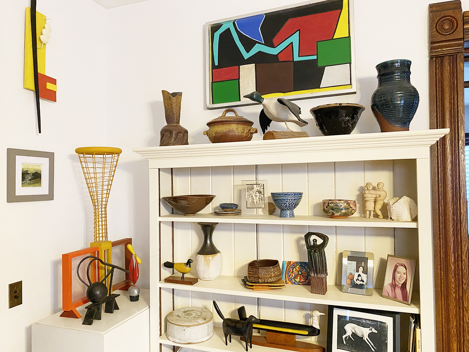 Art pieces on shelves and other storage units.