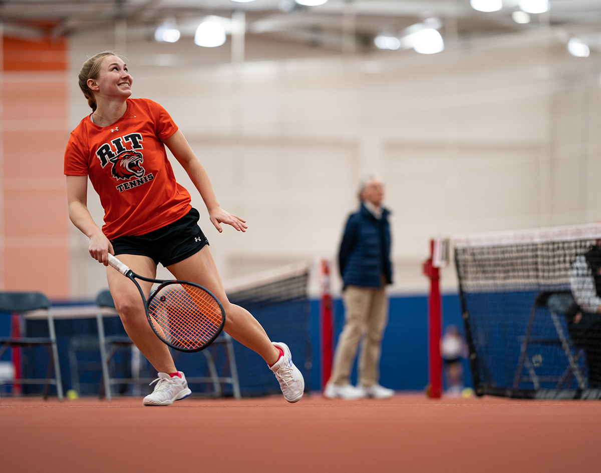 Jackie Drozd playing tennis at RIT.