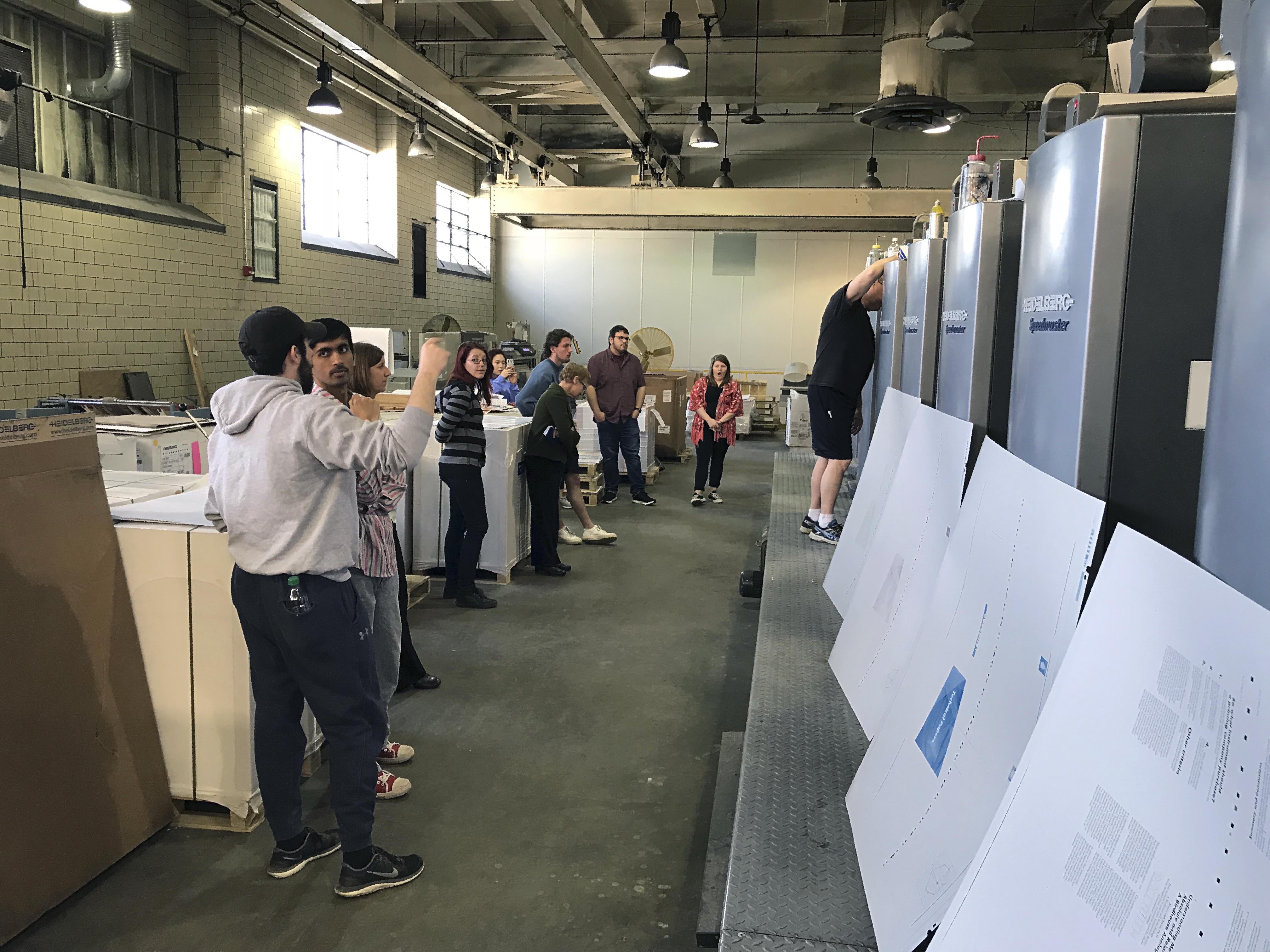 Students standing in a warehouse