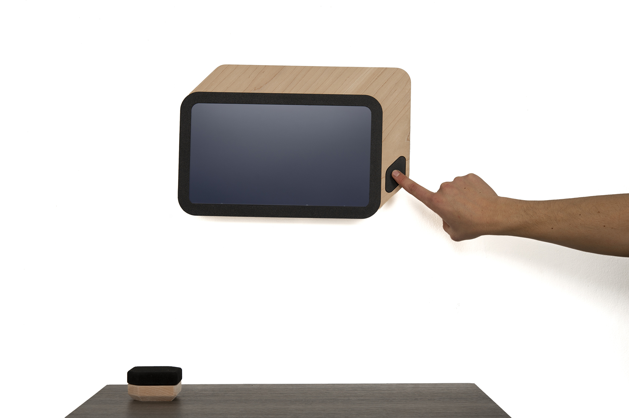 A tablet-looking device wrapped in a wooden box.