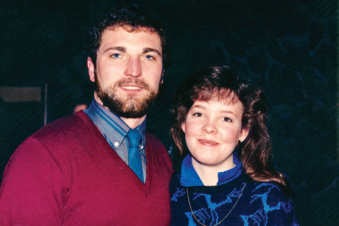 Couple from 1980s stand next to each other.