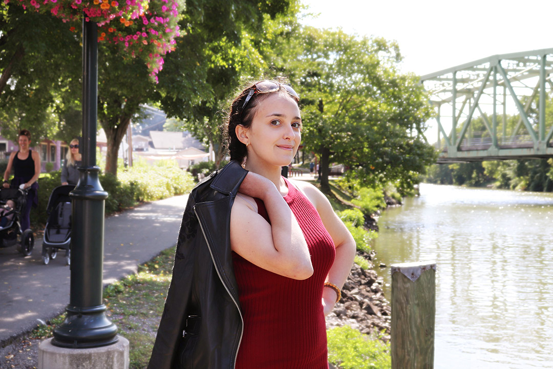 student Isabella Totino standing next to the Erie Canal.