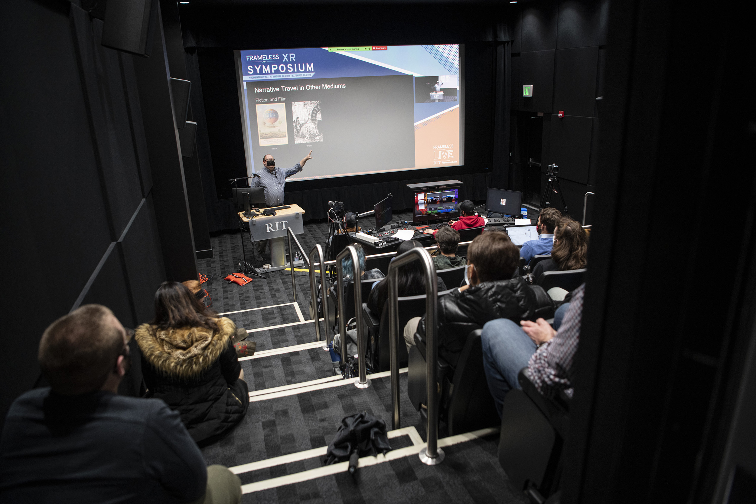 Gary Jacobs presents on a large screen in MAGIC Spell Studios.