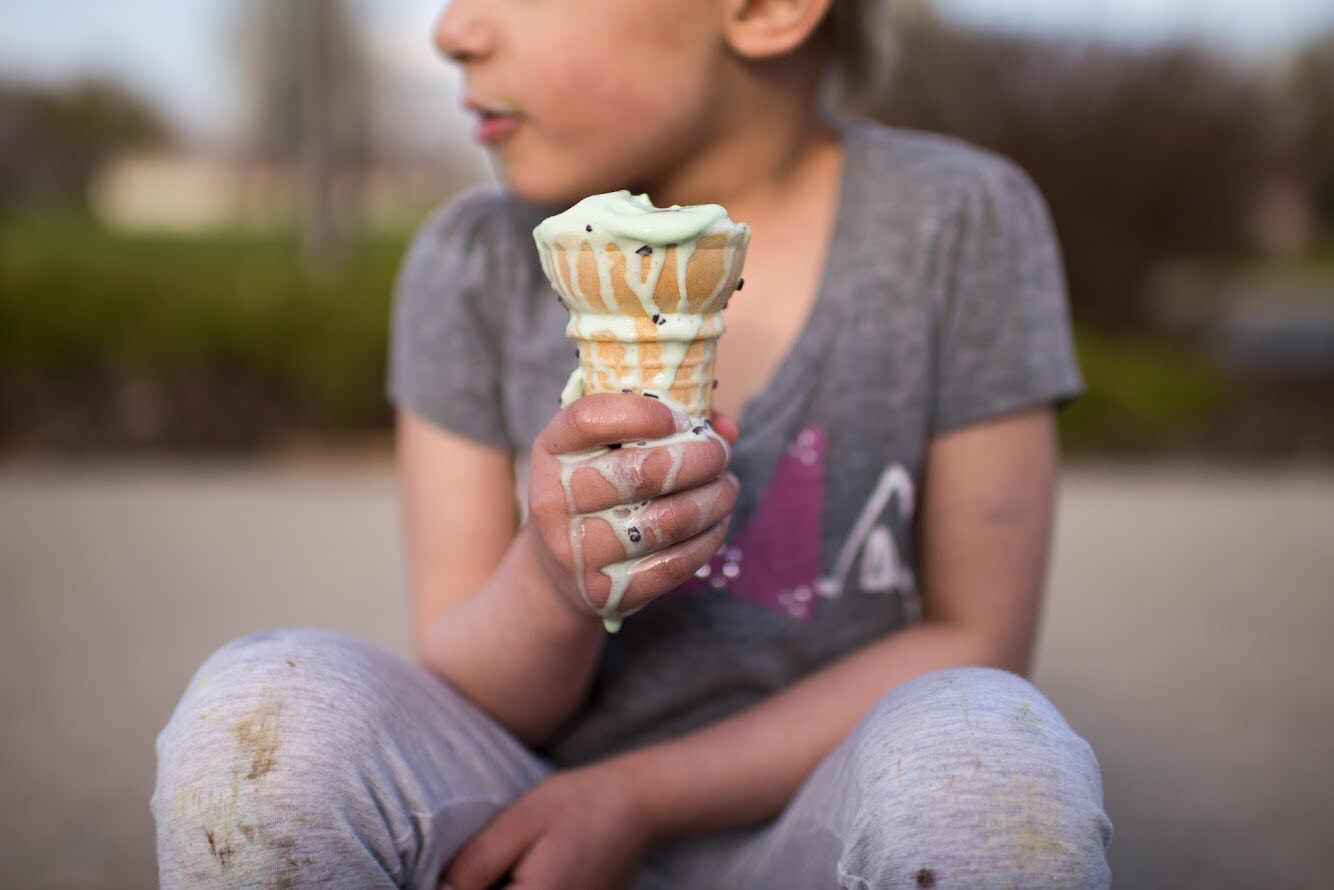 A photo of a young girl holding an ice cream cone