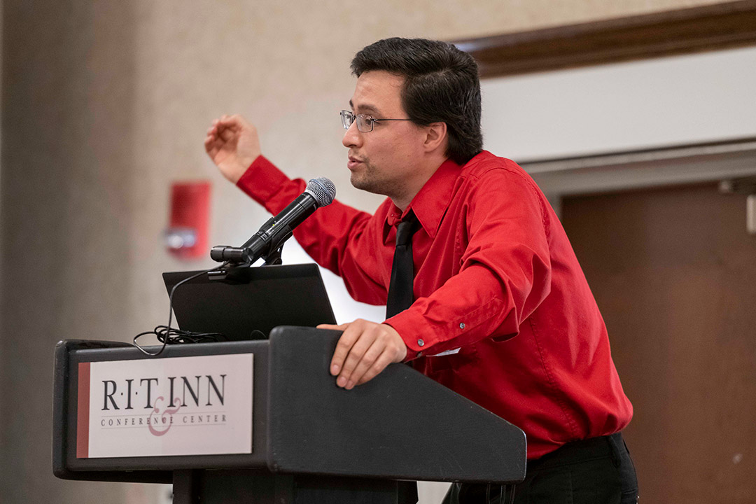 man speaking at a podium.