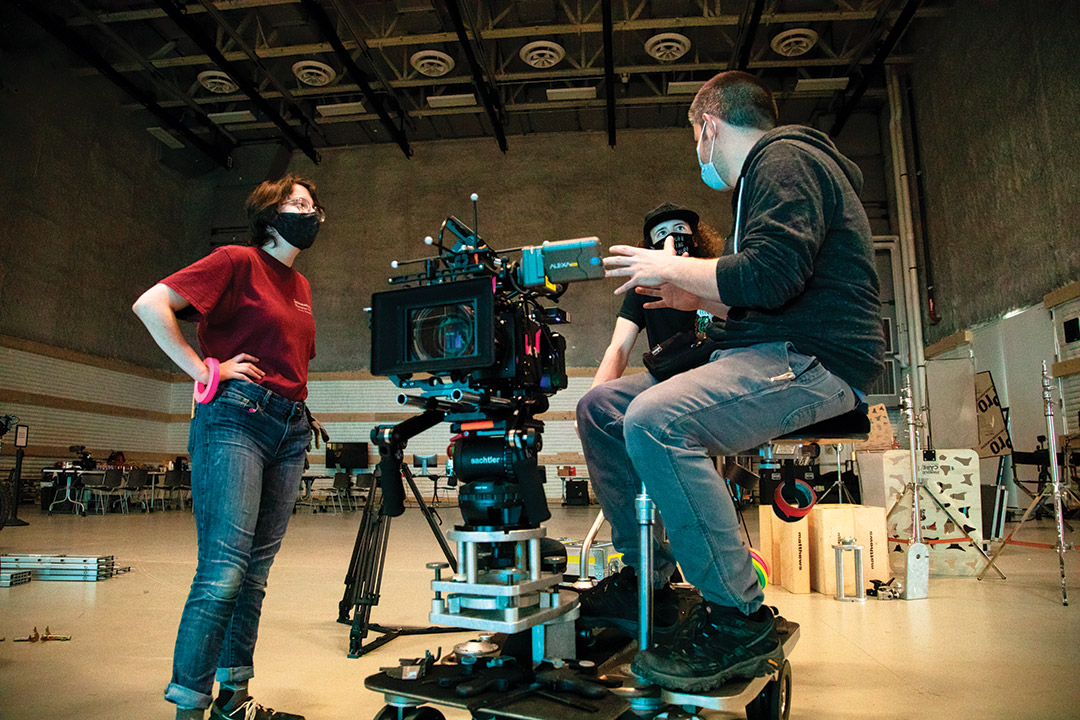 people talking while operating a movie camera.