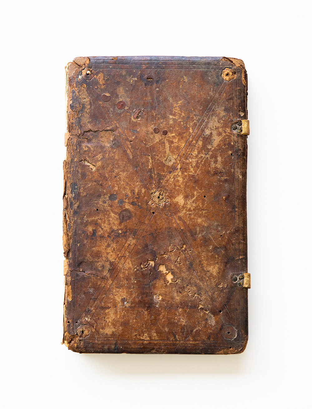 the exterior of a centuries old manuscript which is brown and weathered.