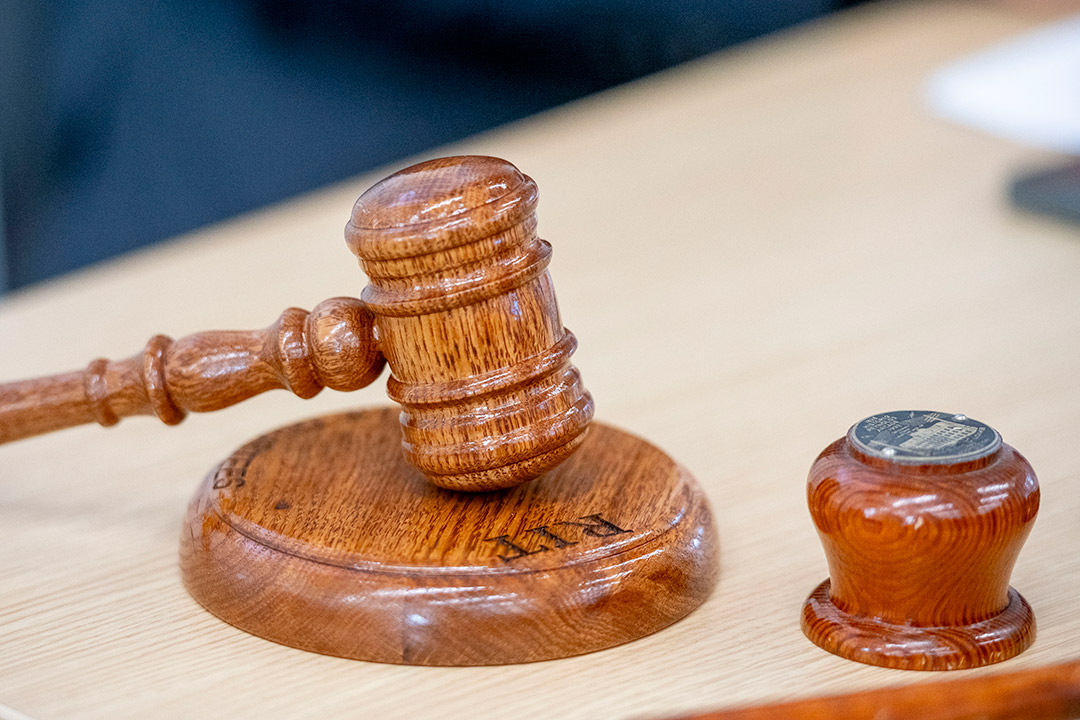 a wooden gavel sits on a table.