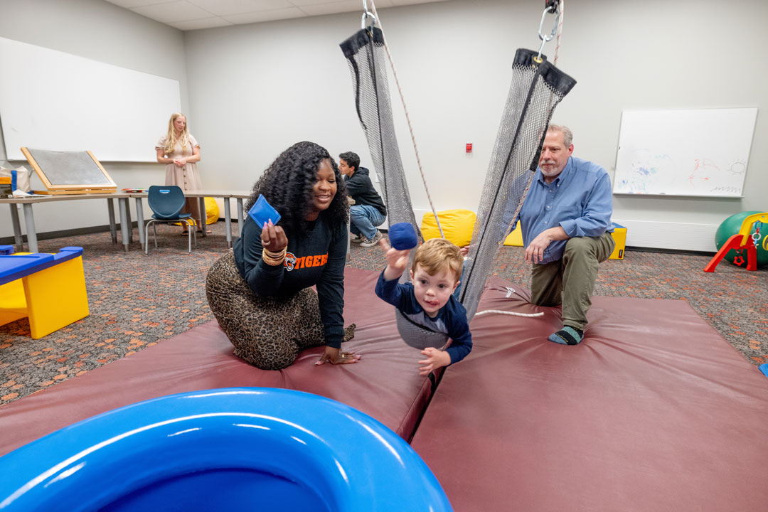 Movement and play are tools used in RIT’s pediatric occupational therapy lab to help children develop fine and gross motor skills, sensory processing, self-regulation, and other functional skills for everyday life. Here, Christopher Alterio, RIT director of occupational therapy, right, is an expert in pediatric therapy.