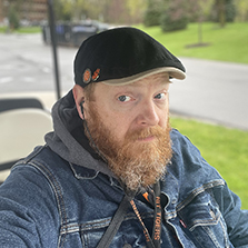 Jeremy Zehr is shown in a hat sitting in a golf cart.