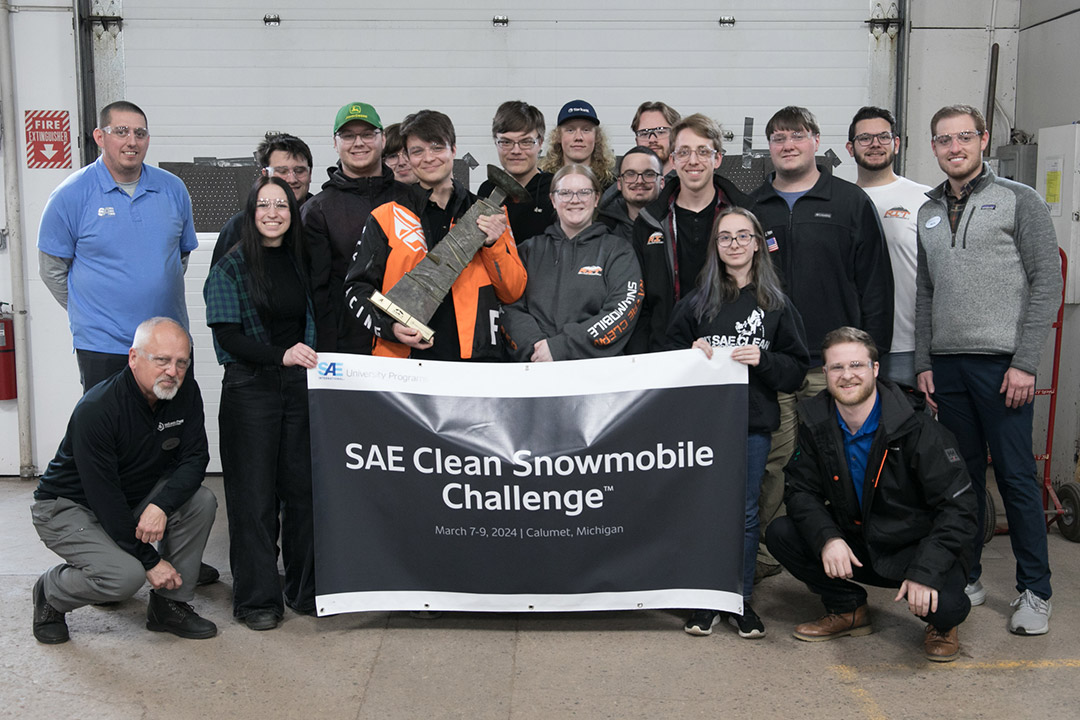 The RIT Clean Snowmobile team is pictured standing together in the snowmobile garage.