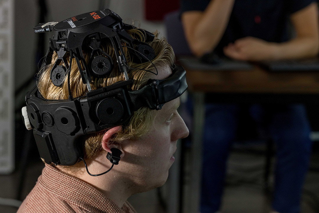 a man wears a prototype EEG device on his head