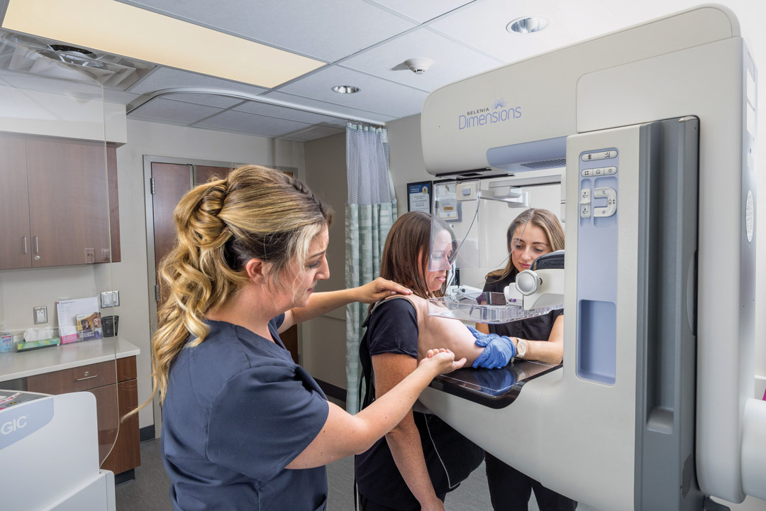 a woman demonstrates MammoVest for practitioners 