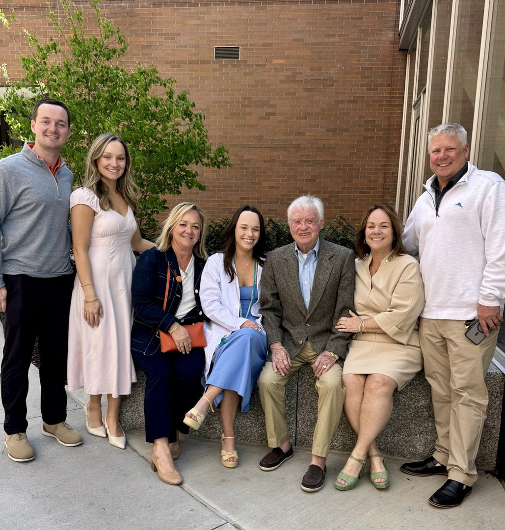 a group photo of multiple generations of a family on the R I T campus
