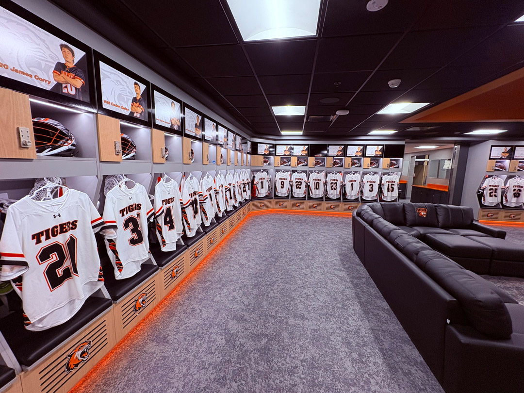 a locker room with R I T logos and student athlete photos nhanging on the wall
