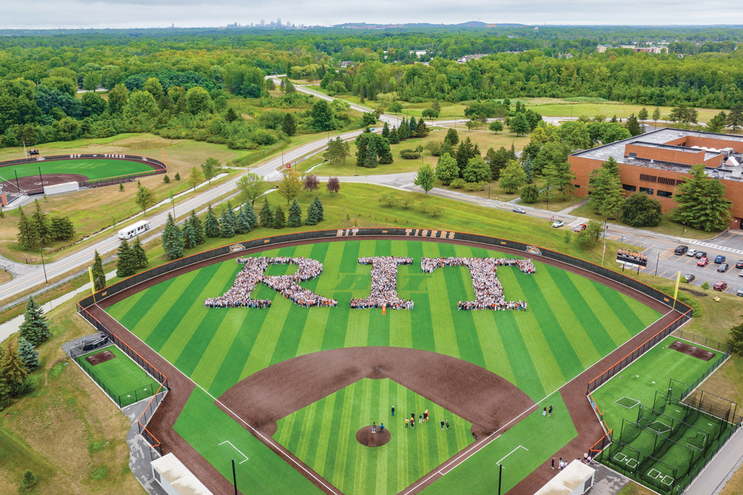 a birds eye view of the R I T campus with new students arranged to form the letters R I T.