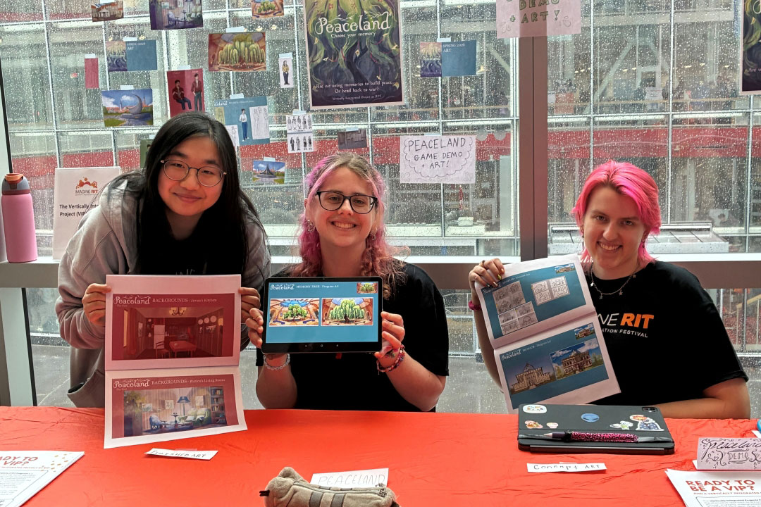 New students join the Peaceland team each semester. Here, three members of the four-person Spring 2026 Art Team, present the game at Imagine R I T 2026.