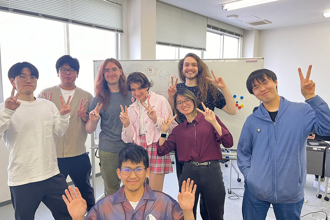 a group of students stand together during a trip to Japan.