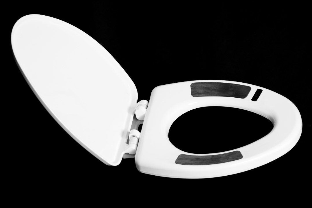 a white toilet seat with black markings that are used for body tracking is shown on a flat background