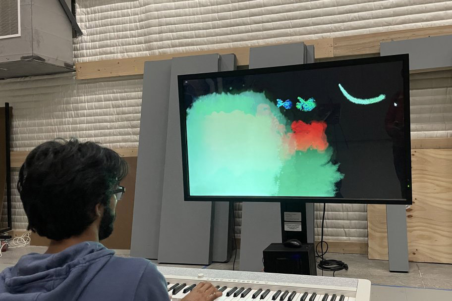 an ImagineRIT visitor is shown visualizing the music they play on a keyboard