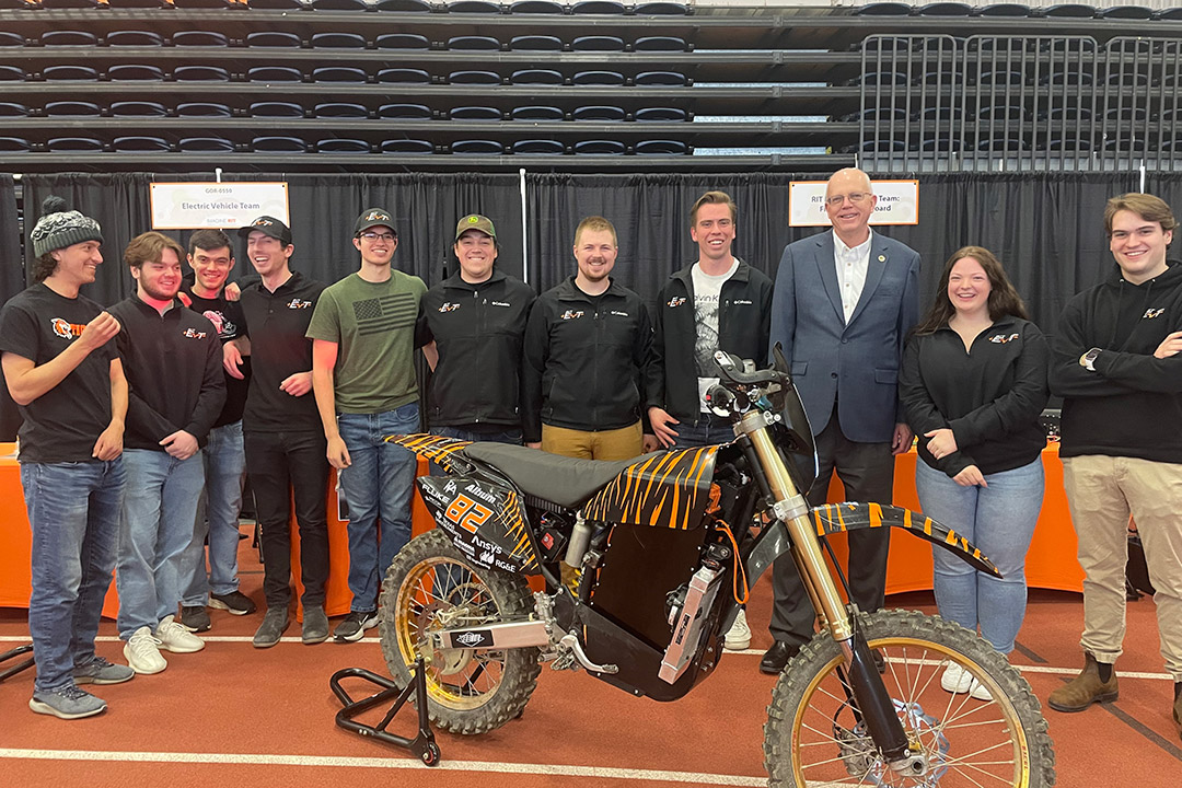 a group of students stand with R I T president David Munson during the Imagine R I T Creativity and Innovation Festival.