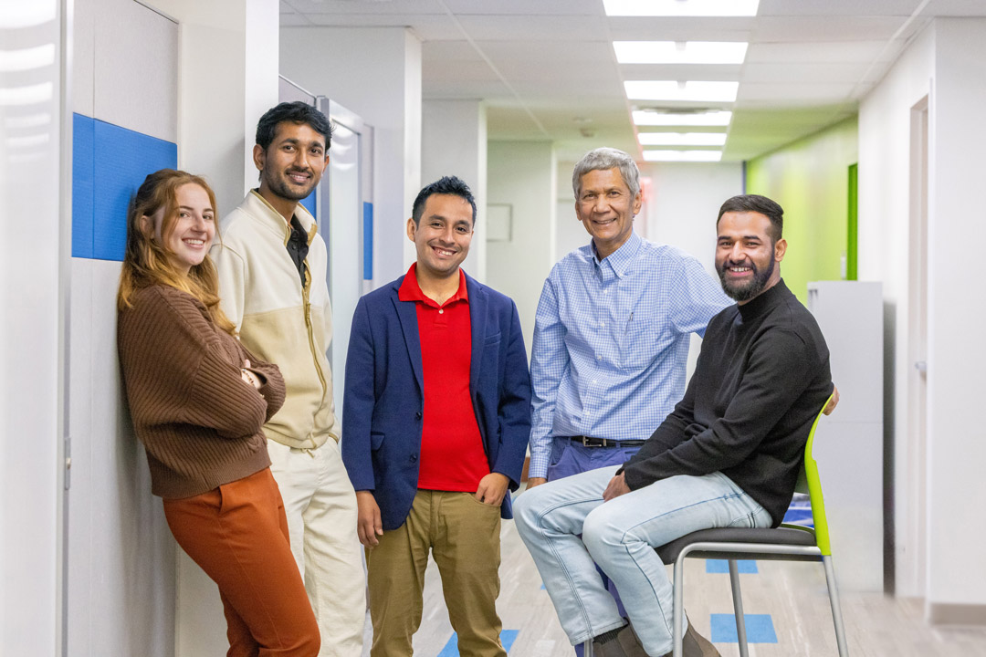 a group of people stand together in a medial office setting.
