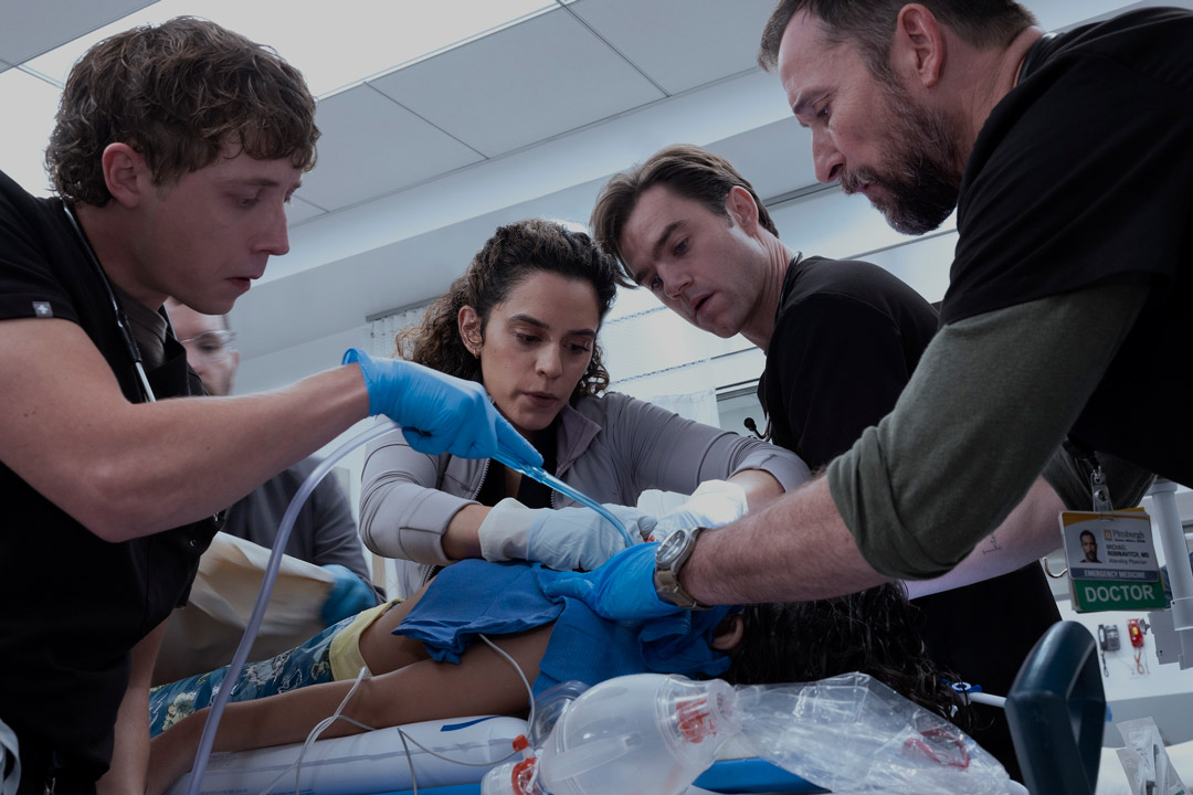 Doctors gather around a patient on a bed