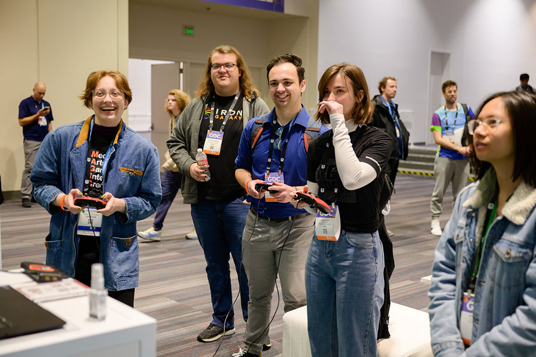 conference-goers trying out a video game.