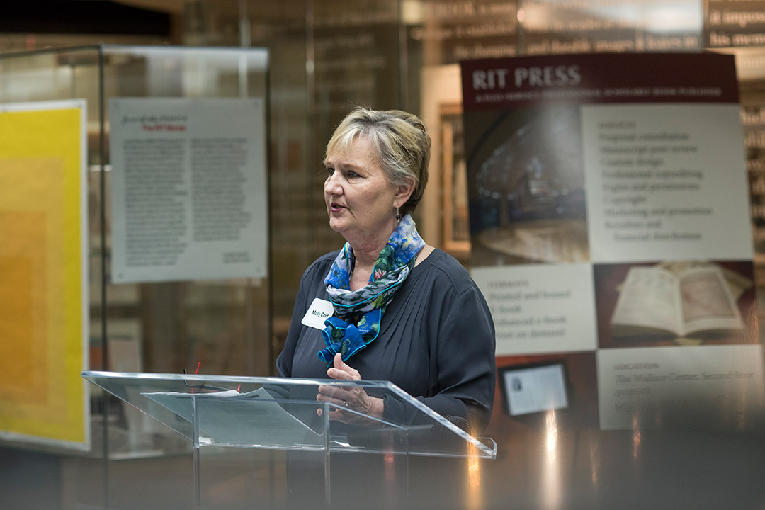 person standing at a podium giving a presentation.