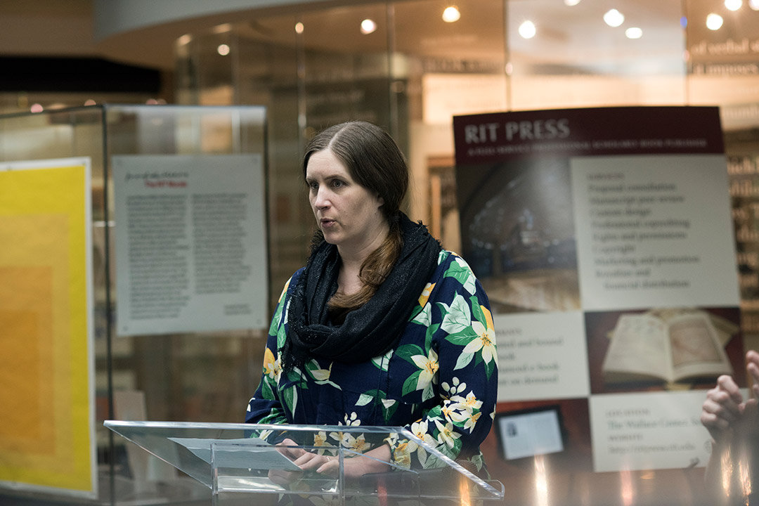 person standing at a podium giving a presentation.