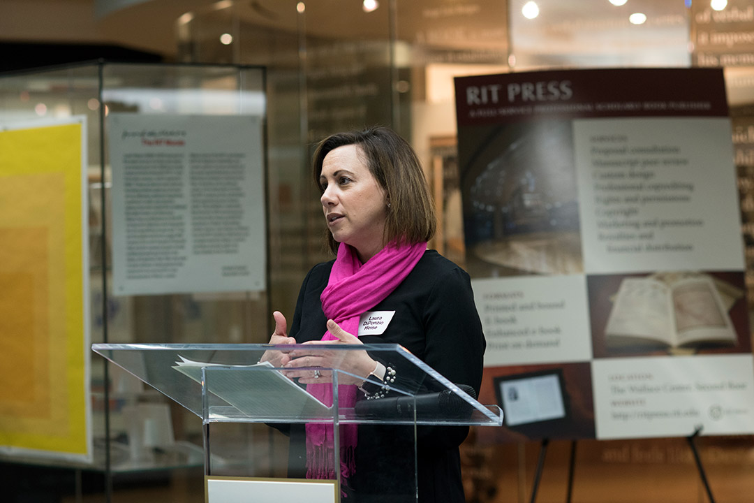 person standing at a podium giving a presentation.