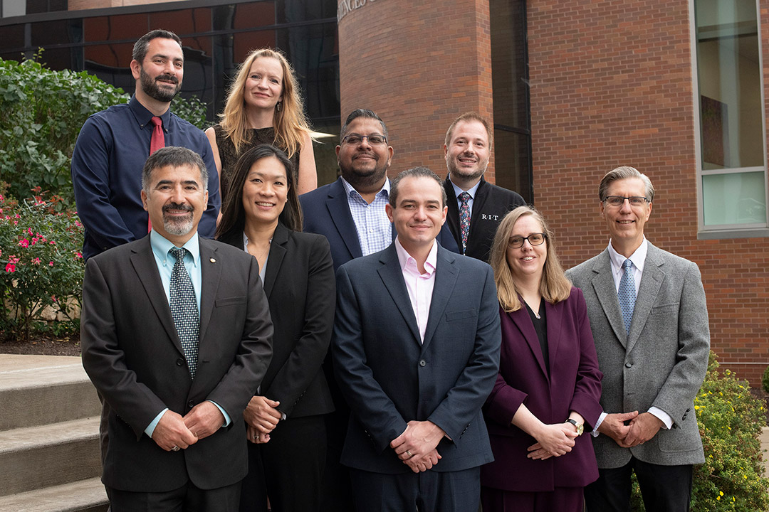 team of faculty-researchers posing outdoors.