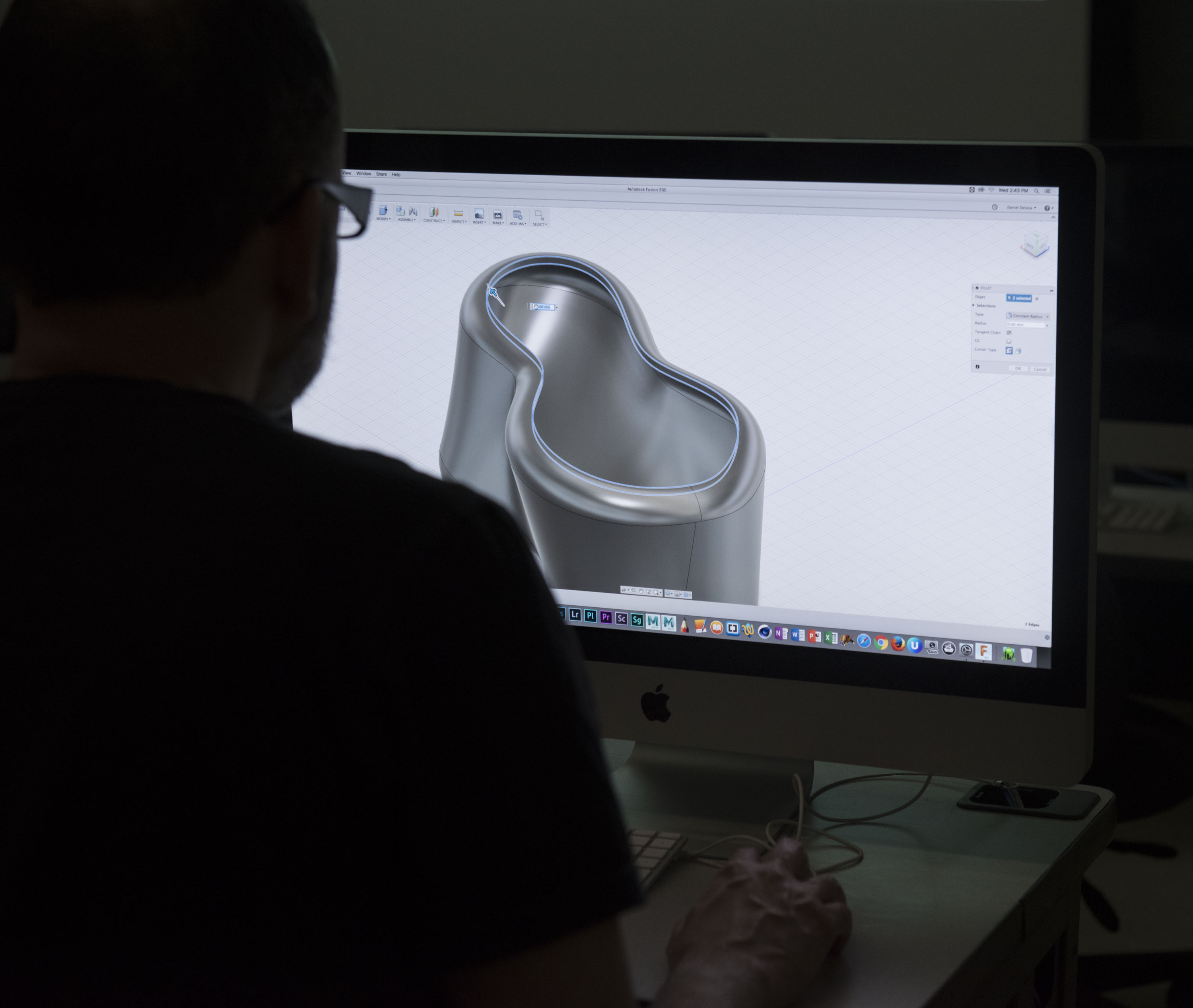 A student is working on 3D CAD software.
