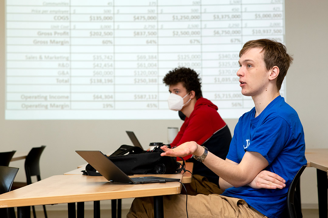 student sitting at a table talking.