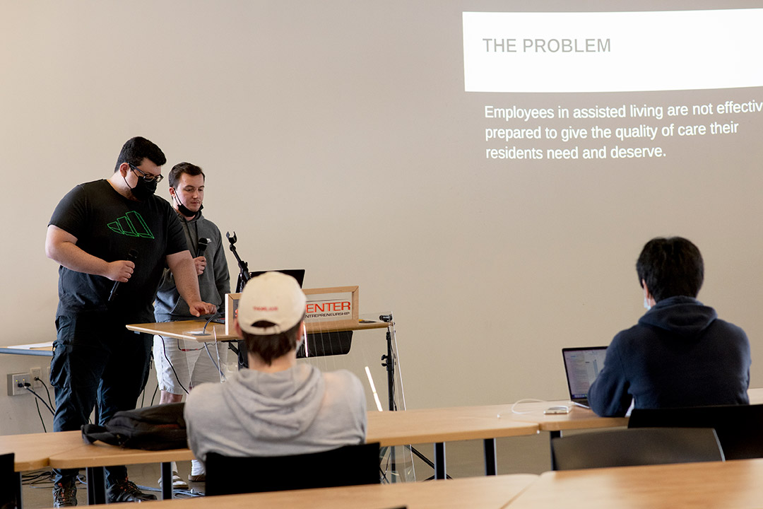 students at a podium giving a presentation.