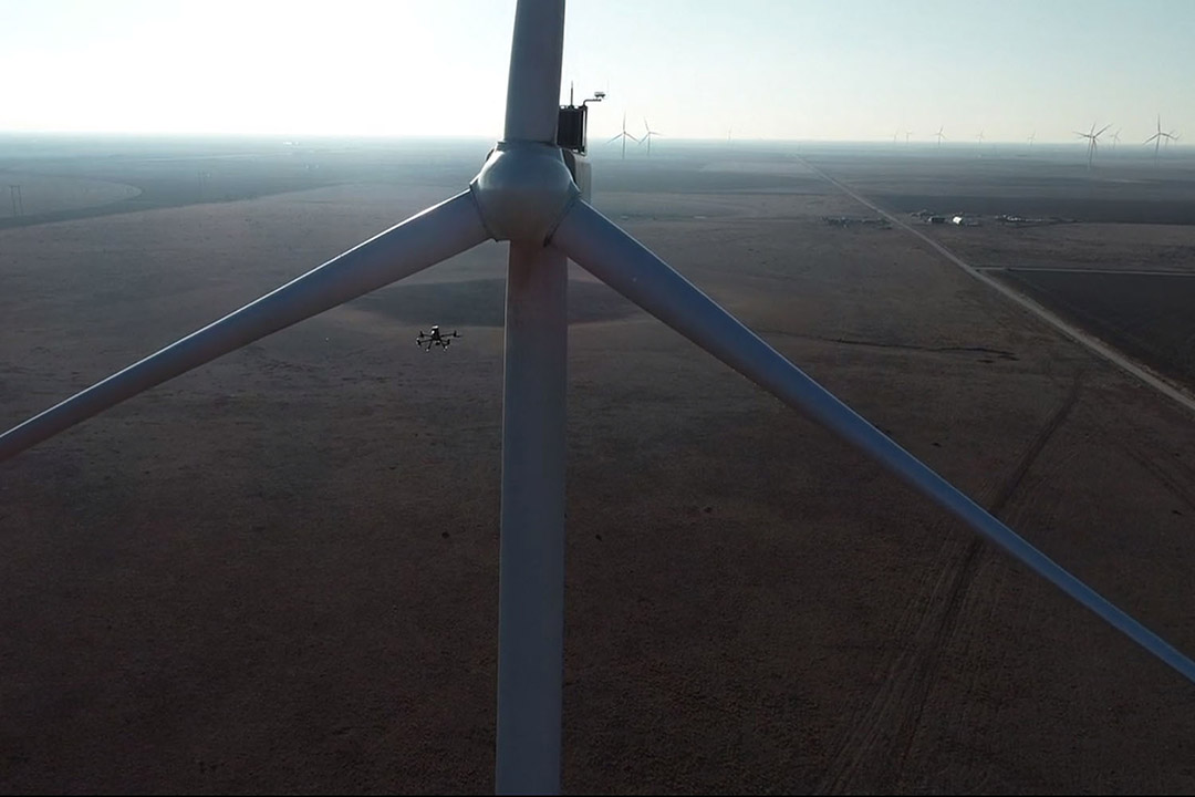 drone flying near a wind turbine.