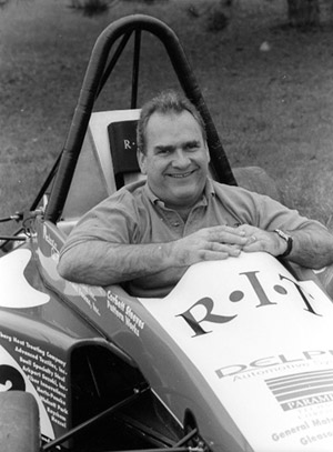 man sitting in Formula race car.