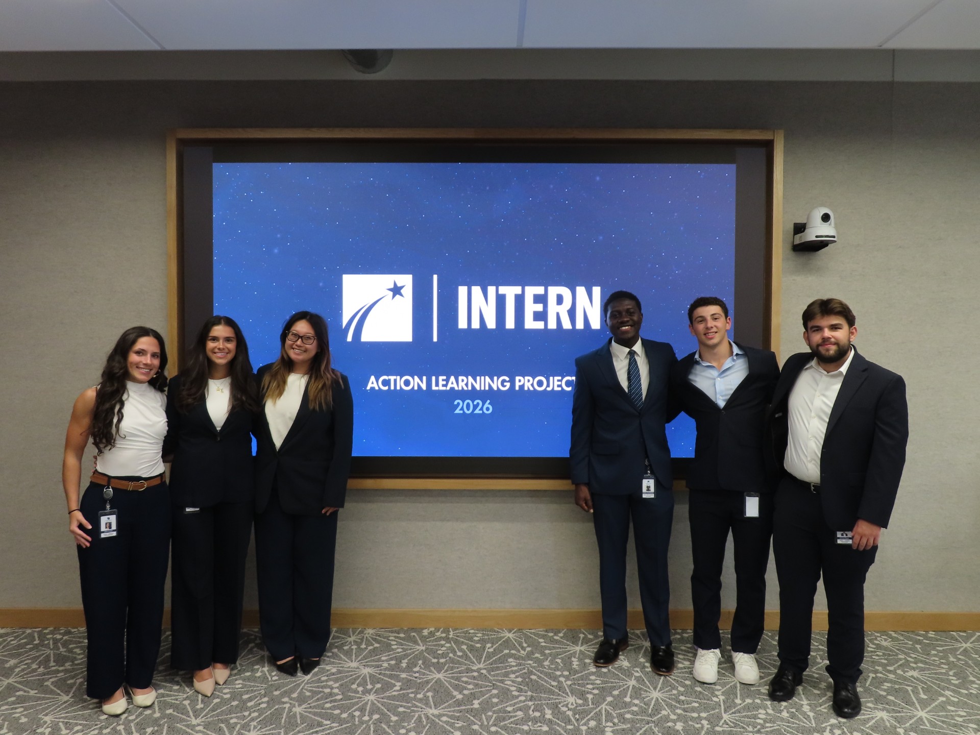 six students standing in front of a constellation brands intern sign