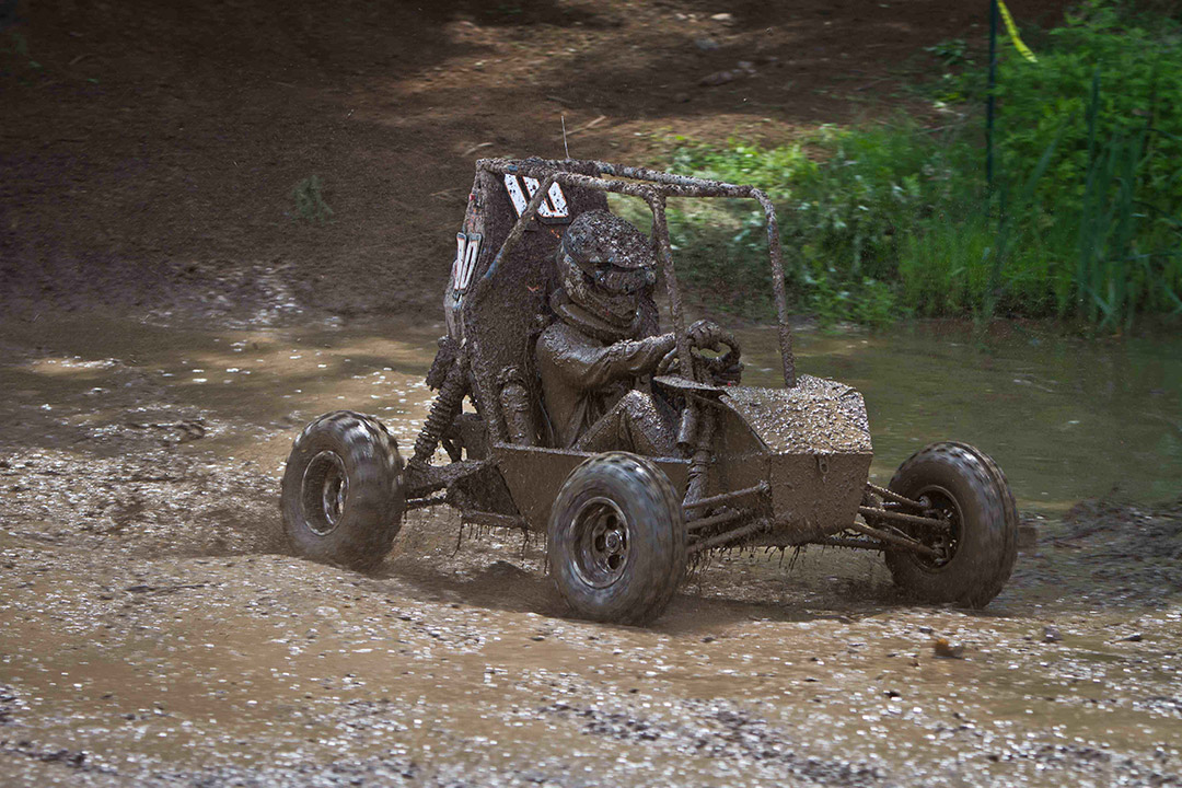 baja car covered in mud.