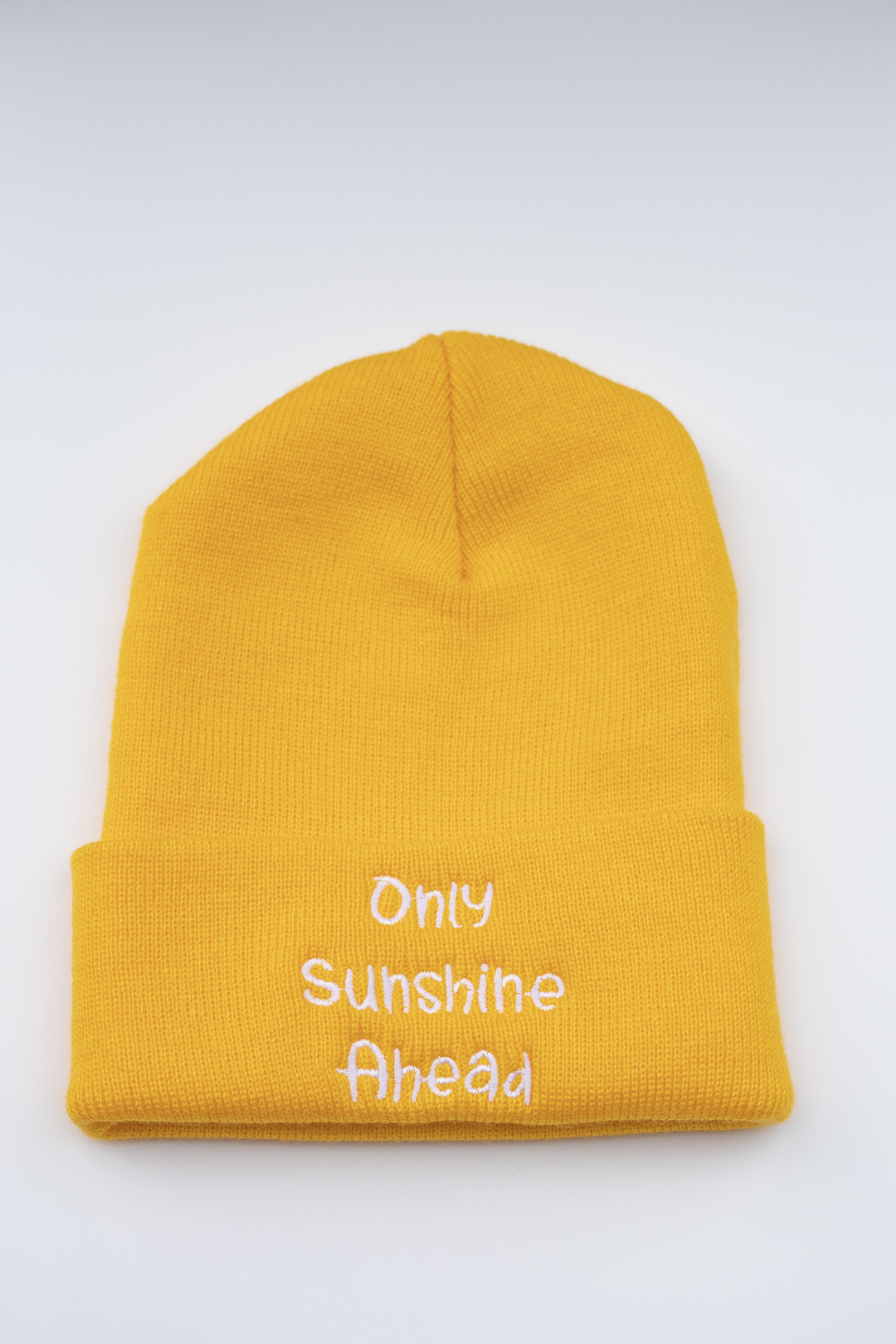 A beanie that says Only Sunshine Ahead.