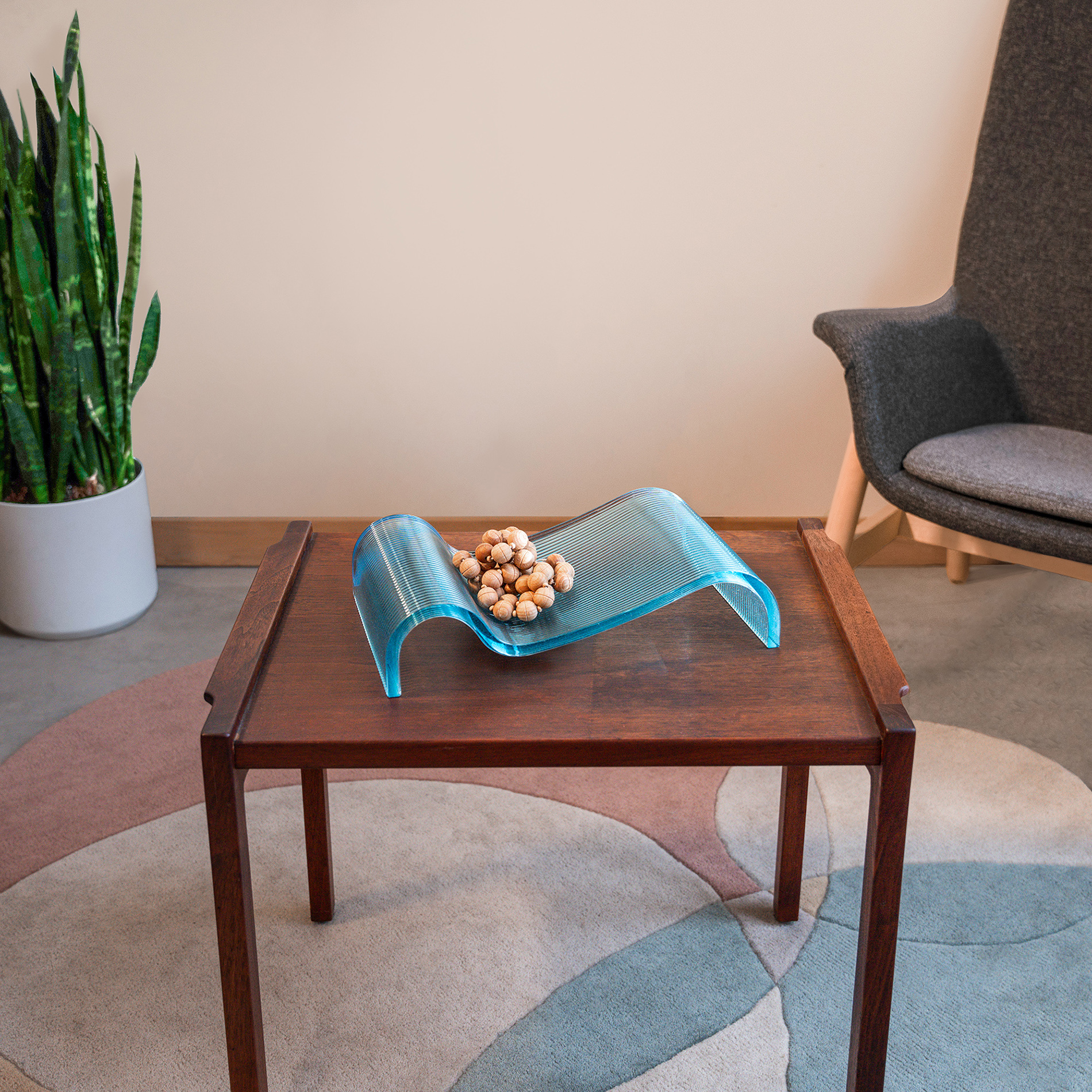 A 3D-printer glass tray, in a blue color, sits on a table.