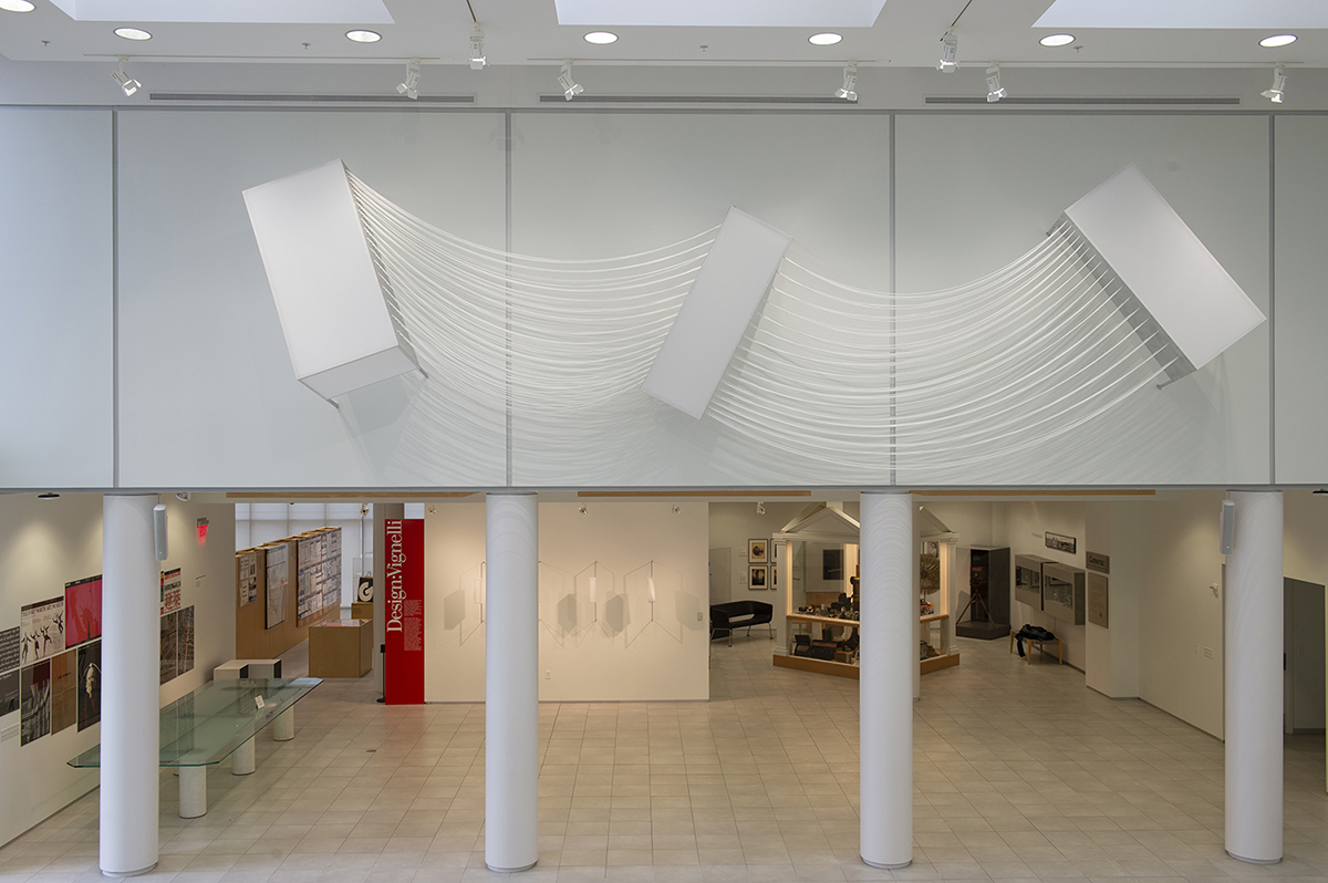 Three large fiber sculpture suspended on high walls.