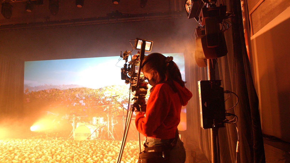 Sarah Alexander operates a camera on a production set.