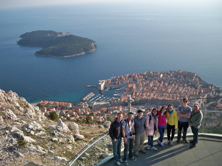 Jack Beck and his students posing with a large body of water behind them.