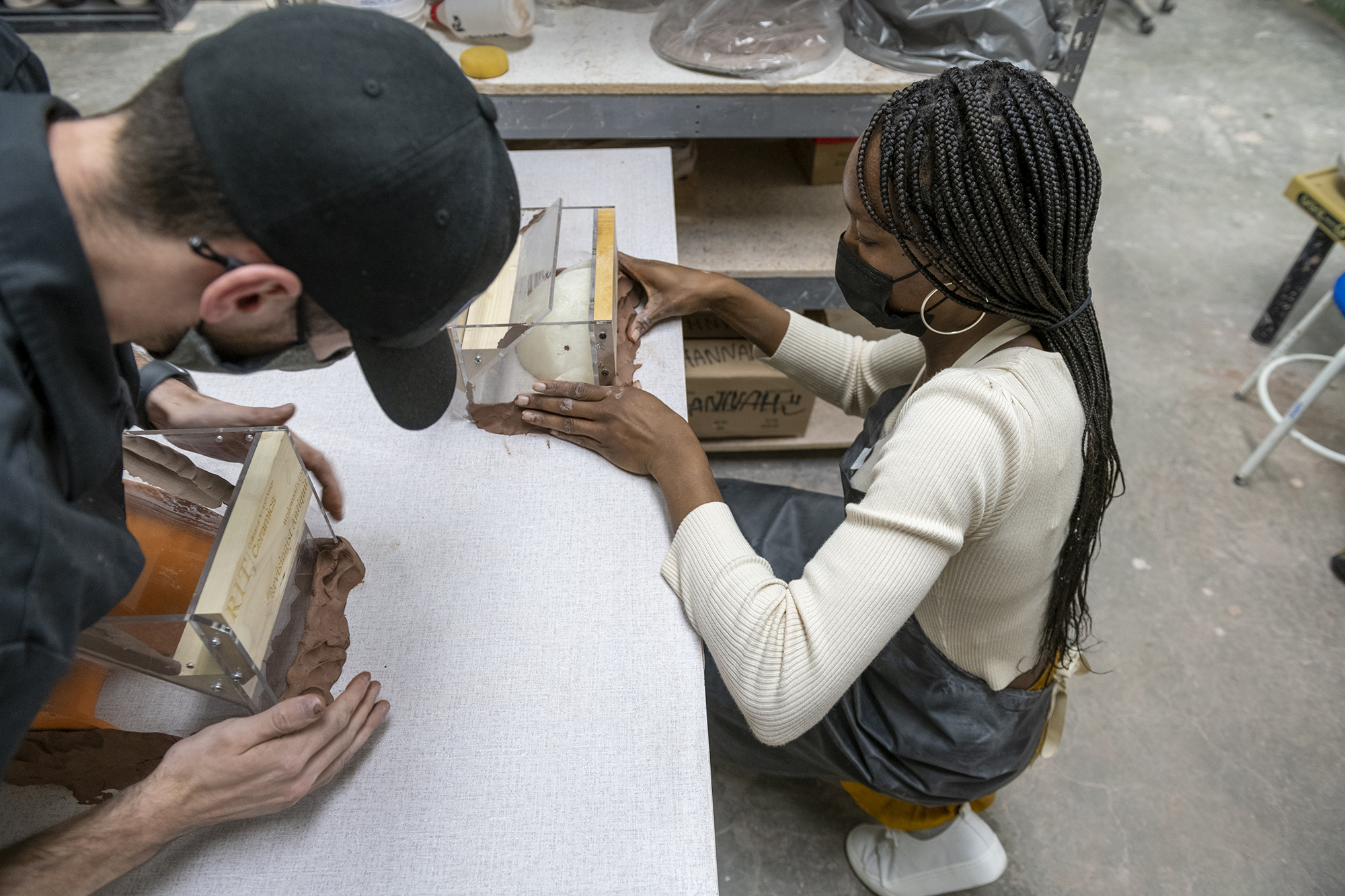 Students prepare mold systems for plaster pouring.