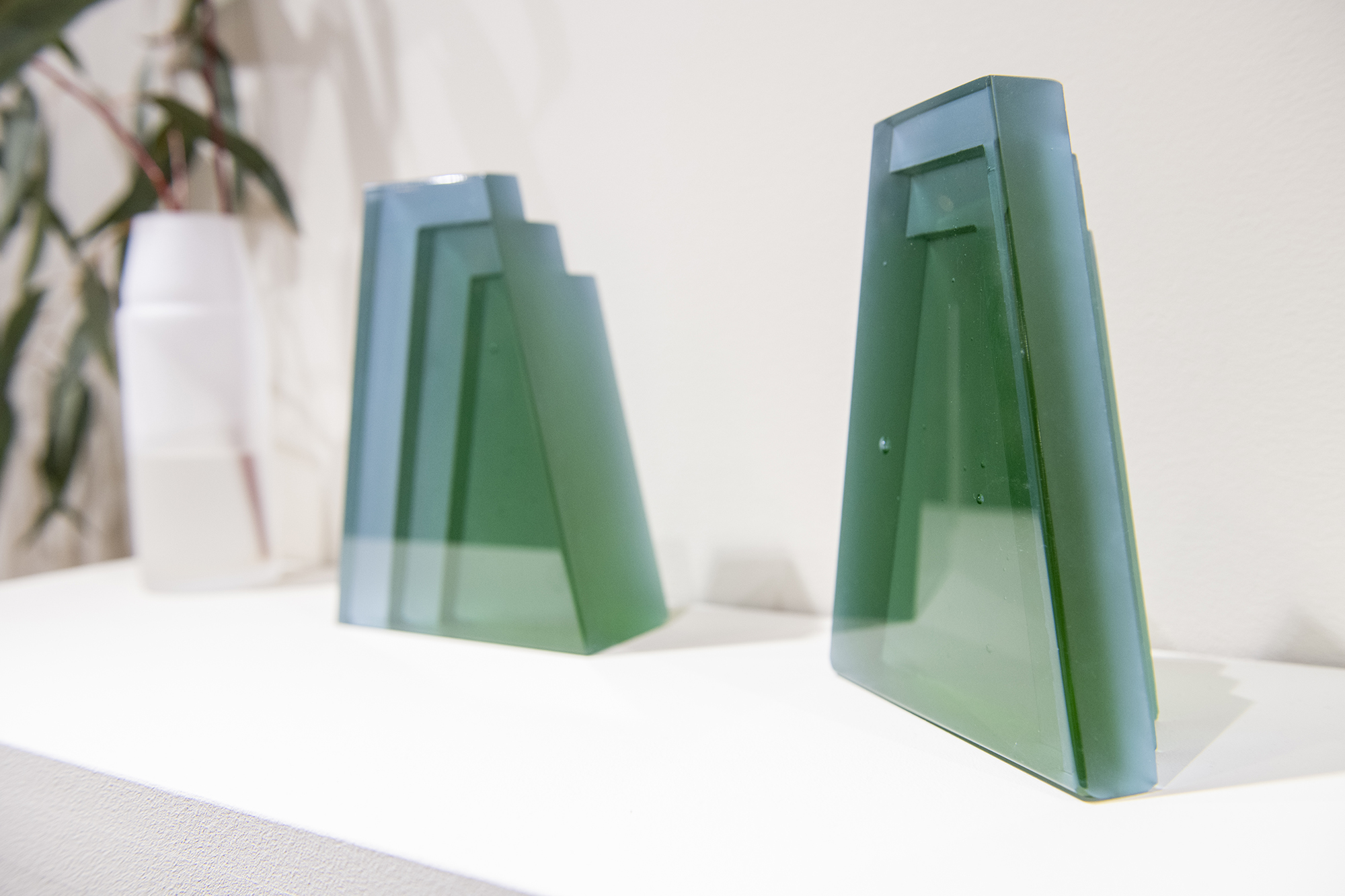 A pair of green, cast glass bookends.